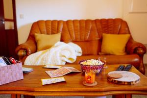 a coffee table with a leather couch in the background at Casa Fundevila Celorico de Basto in Celorico de Basto