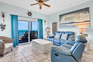 a living room with a couch and a chair at Beachfront home with pool elevator dog-friendly in St. George Island