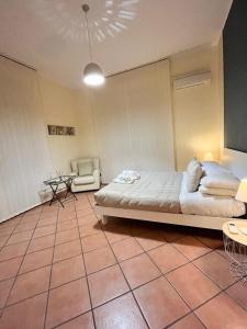 a bedroom with a bed and a table and a chair at Wanderlust Guesthouse in Lamezia Terme