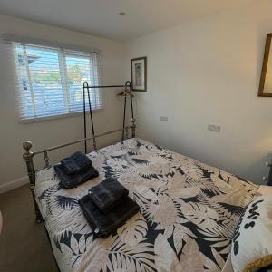 a bedroom with a bed with two pillows on it at Santa's Cottage in Torquay