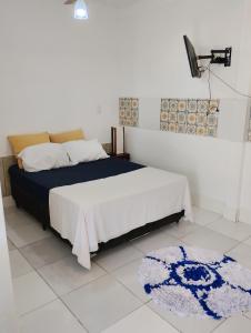 a bedroom with a bed and a rug on the floor at Vereda da Lagoa in Niterói