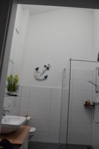 a white bathroom with a sink and a shower at Strandvilla GLOWE - Strandjuwel in Glowe +44 photos