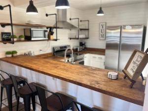 a kitchen with a counter with chairs and a counter top at Turkey Nest by Beyond Expectations Renovated 2BR in Gatlinburg