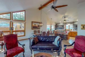 a living room with a leather couch and chairs at Work & Play! Spacious Lake-View Home in Greeley in Greeley