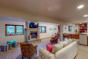 a living room with two couches and a fireplace at Work & Play! Spacious Lake-View Home in Greeley in Greeley