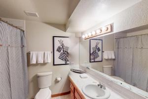 a bathroom with a sink and a toilet and a mirror at Work & Play! Spacious Lake-View Home in Greeley in Greeley +28 photos