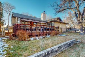 a large house with a large deck in the yard at Work & Play! Spacious Lake-View Home in Greeley in Greeley