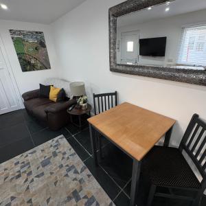 a living room with a table and a couch at Santa's Cottage in Torquay