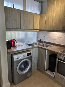 a kitchen with a washing machine and a sink at Sea View Bliss in Ballito +9 photos
