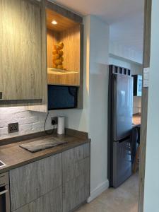 a kitchen with a counter top with a refrigerator at Sea View Bliss in Ballito
