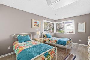 a bedroom with two beds and a window at Sea Woods Villa 4263 in New Smyrna Beach +28 photos