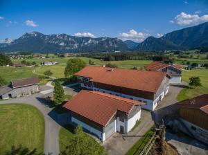 an aerial view of a house with mountains in the background at Wimmerhof - Chiemgau Karte in Inzell