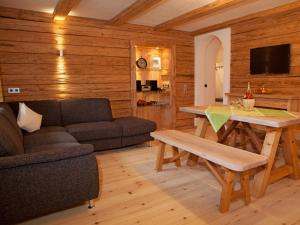 a living room with a couch and a table at Wimmerhof - Chiemgau Karte in Inzell