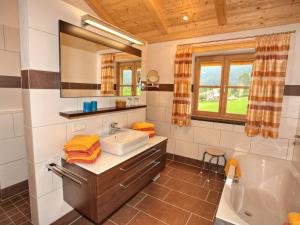 a bathroom with a sink and a tub and a mirror at Wimmerhof - Chiemgau Karte in Inzell +57 photos