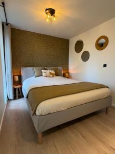 a bedroom with a large bed in a room at Lavand'in Durbuy in Durbuy