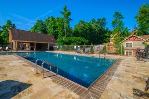 a swimming pool in a yard with a house at Bears Haven – Elegant 3 BR Chalet Game Area, Hot Tub, see through fire place in Gatlinburg
