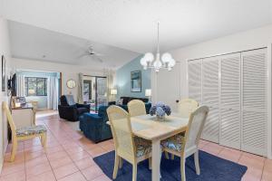 a dining room and living room with a table and chairs at Sea Woods Villa 4263 in New Smyrna Beach