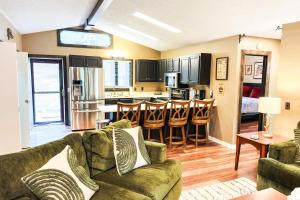 a living room with a couch and a kitchen at Massanutten Chalet View & Fire Table Deck in McGaheysville