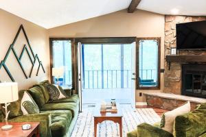 a living room with a couch and a fireplace at Massanutten Chalet View & Fire Table Deck in McGaheysville