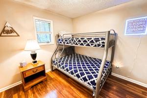 a bedroom with two bunk beds and a lamp at Massanutten Chalet View & Fire Table Deck in McGaheysville +26 photos