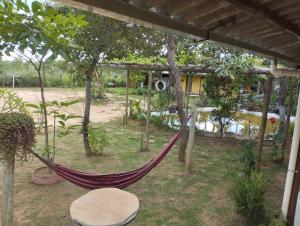 a hammock in the middle of a garden at COMPARTILHADO Do TERRÃO in Três Marias