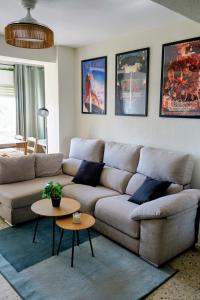 a living room with a couch and two tables at Casa Belice Huelva in Huelva