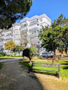 a park bench in front of a building at Casa Belice Huelva in Huelva +18 photos