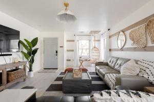 a living room with a couch and a table at Copper Cactus House Pool, Spa, Golf! in Queen Creek