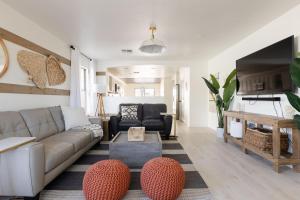 a living room with a couch and a table at Copper Cactus House Pool, Spa, Golf! in Queen Creek