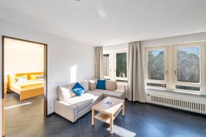 a living room with a couch and a table at CENTRO Appartamento Ascona in Ascona