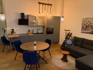 a living room with a table and a kitchen at Strandvilla GLOWE - Strandjuwel in Glowe