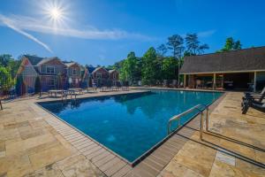 a large swimming pool in a residential neighborhood at Poolside Paradise - Luxe 4BR Chalet with Indoor Pool, Theater and Game Room in Gatlinburg