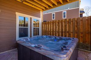 a hot tub on the side of a house at Poolside Paradise - Luxe 4BR Chalet with Indoor Pool, Theater and Game Room in Gatlinburg +47 photos