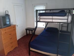 a bedroom with a bunk bed and a television at Altgeld House in South Bend