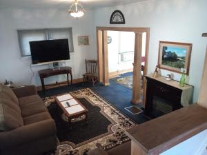 a living room with a couch and a fireplace at Altgeld House in South Bend