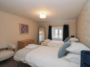 a bedroom with two beds and a mirror at Pirnies in Pitlochry
