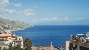 a view of the ocean from a building at TPH Rooms in Taormina