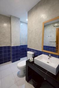 a bathroom with a white toilet and a sink at Na Ville Resort in Ban Huai Yai +15 photos