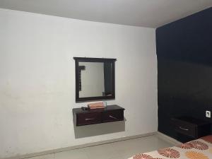 a bathroom with a mirror on a white wall at Motel Love in Altamira +4 photos