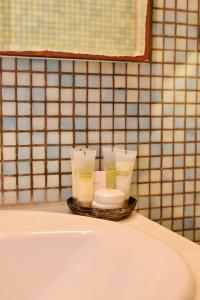 a tray with three candles sitting on top of a bathroom sink at Mesta Loft in Mestá +26 photos
