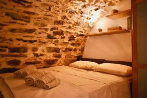 a bed in a room with towels on it at Mesta Loft in Mestá