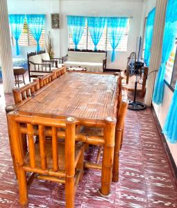 a large wooden table in a living room at Tamari's Rest House in Lian