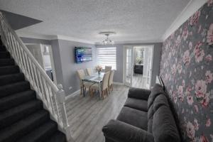 a living room with a couch and a table at Cloverdale in Bedlington