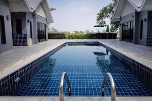 a swimming pool in the middle of a house at Na Ville Resort in Ban Huai Yai