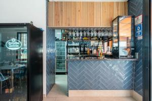 a bar in a restaurant with a counter with alcohol at Hotel Cala Arena in San José +11 photos