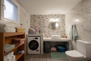 a bathroom with a washing machine and a sink at Villa Lydia Kariani in Karianí +34 photos