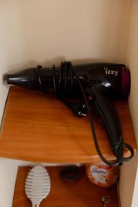 a hair dryer sitting on top of a wooden shelf at Villa Lydia Kariani in Karianí