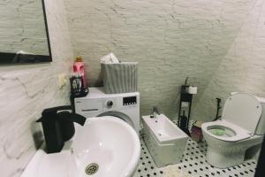 a white bathroom with a sink and a toilet at Cottage lima in Kutaisi +65 photos