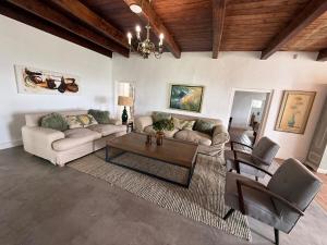 a living room with a couch and a table at Firgrove Country House in Robertson