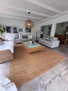 a living room with couches and a coffee table at Firgrove Country House in Robertson